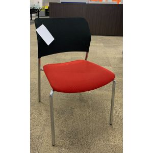 Front view Pre-owned Harter side chair has black mesh back, red fabric seat and (4) metallic silver post legs. Armless. -B GRADE-